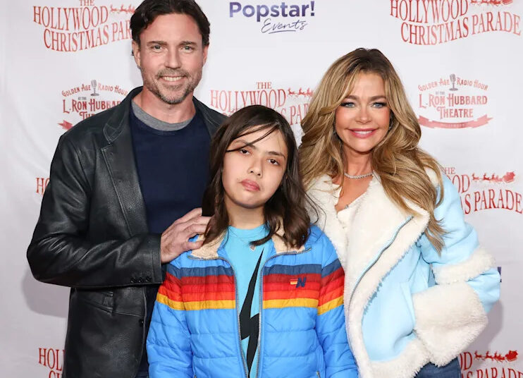 Denise Richards, right, poses with daughter Eloise Joni Richards, center, and estranged husband Aaron Phypers at the 91st anniversary of the Hollywood Christmas Parade on Nov. 26, 2023.