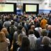 A large crowd gathers in a gymnasium for a community meeting hosted by the Denver Broncos at the La Alma Recreation Center to share preliminary concepts for the proposed new stadium and mixed-use community at Burnham Yard in Denver on Feb. 12, 2026. (Photo by RJ Sangosti/The Denver Post)