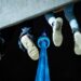 Fans of Drake dangle their feet off of a concrete structure as they gather near the CN Tower for a video projection promoting the upcoming album ICEMAN in Toronto on Friday, May 14, 2026. THE CANADIAN PRESS/Arlyn McAdorey