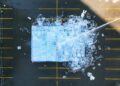 Overhead as water is sprayed on large installatin of ice blocks