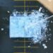Overhead as water is sprayed on large installatin of ice blocks