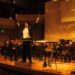 Eric André conducting on stage alongside Prateek Rajagopal, who collaborated with him on his debut classical album.