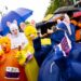 Members of the Wright family from Chatham, Ill., and Farmer City, Ill., navigate their costumes to enjoy mini corn dogs at one of the food stops during the Fat Ass 5K & Street Party for Charity along the streets of downtown, Saturday, May 11, 2019, in Springfield, Ill. The Fat Ass 5K is a race throughout downtown that includes stops for beer, corn dogs, donuts and ice cream and has donated over $2 million to charity since 2008.
