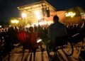 Bob Roark, right, and Penny Machmer, left, watch the Beach Boys perform from ADA accessible seating areas at Levitt Pavilion in Denver on Aug. 14, 2024. (Photo by Helen H. Richardson/The Denver Post)