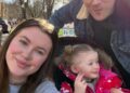 A family of three, including Ireland Baldwin, poses for a selfie on a sunny day.