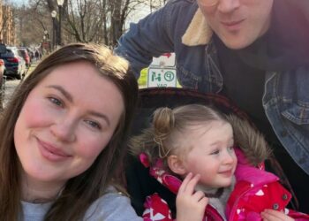 A family of three, including Ireland Baldwin, poses for a selfie on a sunny day.