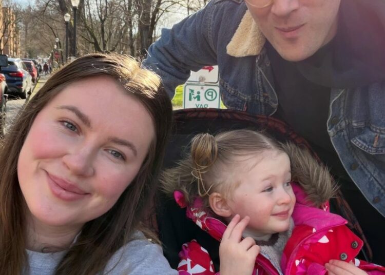 A family of three, including Ireland Baldwin, poses for a selfie on a sunny day.