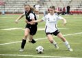 Alexandria Lyles and Wren Stewart battle for the ball.