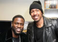 Kevin Hart and Nick Cannon smiling, both wearing black outfits. Kevin has a velvet jacket, and Nick wears a beanie and leather jacket.