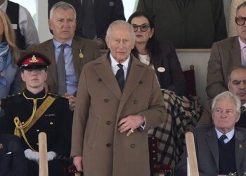 King Charles III standing as members of the King's Troop, Royal Horse Artillery perform a Royal salute in the Castle arena.