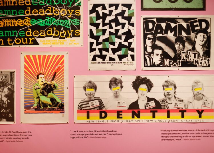 Punk posters are displayed in a museum.