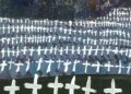 Image may contain Cross Symbol Graveyard Outdoors and Person