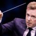 Conductor Daniel Harding raises his baton