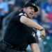 Home plate umpire John Libka throwing out Athletics hitting coach Chris Cron during baseball game.