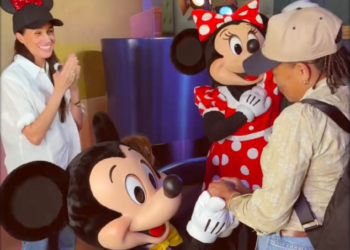 Mickey Mouse and Minnie Mouse interacting with children in a playful setting.