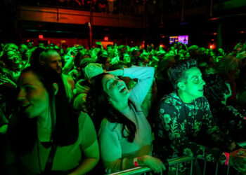Bethany Vermette, 49, center, sings along as country singer Lily Rose performs on Thursday, May 14, 2026 at District 142, a music venue in downtown Wyandotte, Mich.
