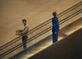 Sacha Baron Cohen as Damien Sachs and Rosamund Pike as Alex Fox
