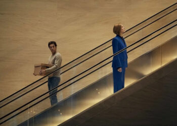 Sacha Baron Cohen as Damien Sachs and Rosamund Pike as Alex Fox