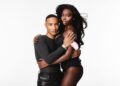 Two individuals embracing, featuring distinct clothing styles.
