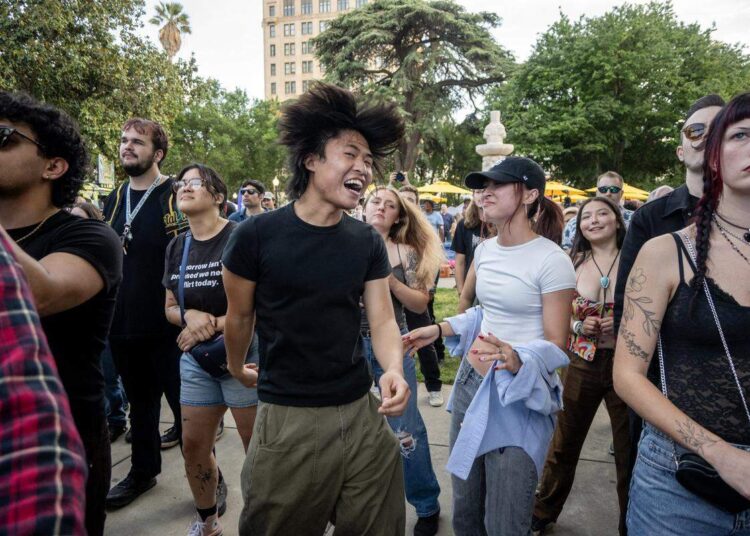 Mika Faye and Courtney Hoang dance to the music played by Ashley Jaguar at Concerts in the Park across from Sacramento City Hall on Friday.