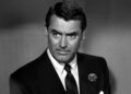 Dick Nugent wearing a black suit and tie in "The Bachelor and the Bobby-Soxer"