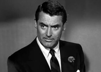Dick Nugent wearing a black suit and tie in "The Bachelor and the Bobby-Soxer"