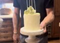 Prince Harry holding their anniversary cake.
