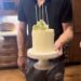 Prince Harry holding their anniversary cake.