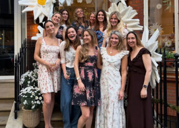 Natasha Archer and a group of women posing in front of a store.