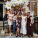 Natasha Archer and a group of women posing in front of a store.