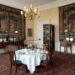 Image may contain Architecture Building Dining Room Dining Table Furniture Indoors Room Table Chandelier and Lamp