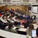 Group of academics and students listening to a panel