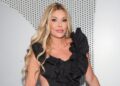 Brandi Glanville poses in a black dress
