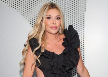 Brandi Glanville poses in a black dress