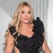 Brandi Glanville poses in a black dress