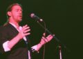 Alex Ligertwood sings on stage.