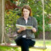 Princess Eugenie reading a book while sitting on a swing