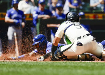 Kansas City Royals designated hitter Salvador Perez (13) slides home to score a run on a sacrifice fly by left fielder Isaac Collins (1, not pictured) against Seattle Mariners catcher Jhonny Pereda (5) during the fourth inning at T-Mobile Park.&nbsp; Joe Nicholson-Imagn Images