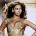 Beyoncé, pictured in 2009, glances to the side of the stage as she performs in a sparkling gold body suit