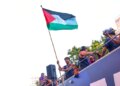 FC Barcelona player Lamine Yamal holds a Palestinian flag as he celebrates with his team atop a bus after winning the Spanish La Liga title in Barcelona.