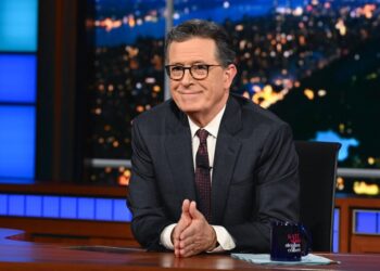 Stephen Colbert at the desk of The Late Show.