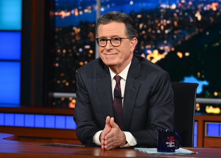 Stephen Colbert at the desk of The Late Show.