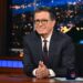 Stephen Colbert at the desk of The Late Show.