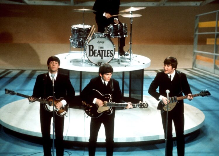 The band The Beatles performing.