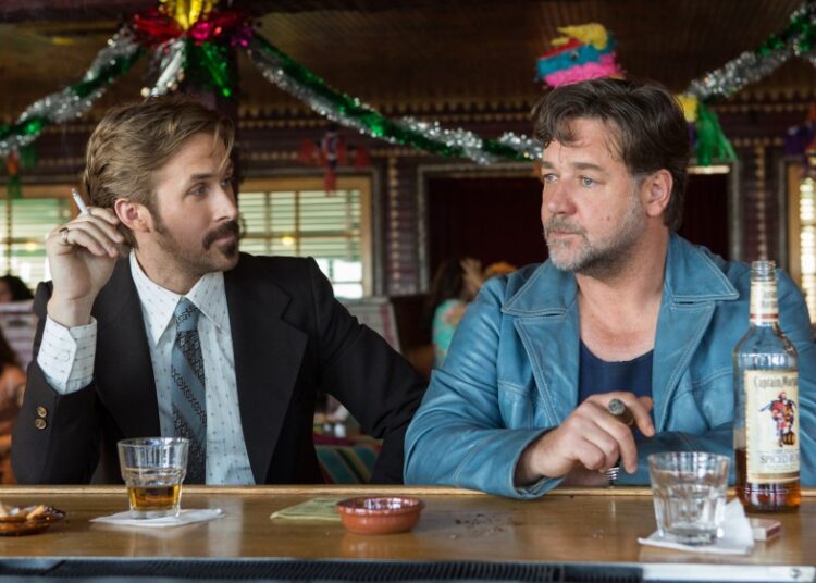 This image released by Warner Bros. shows Ryan Gosling, left, and Russell Crowe in a scene from