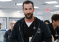 Noah Wyle's  Dr. Michael Robinavitch stands in the ER with hsi staff working in the background in The Pitt