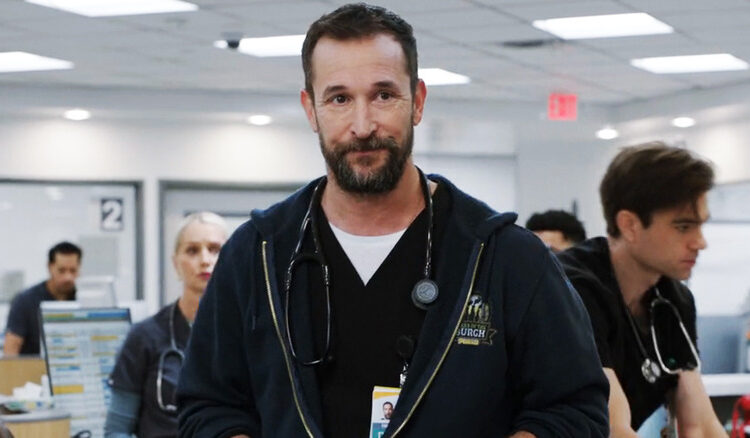 Noah Wyle's  Dr. Michael Robinavitch stands in the ER with hsi staff working in the background in The Pitt