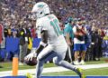 Miami Dolphins wide receiver Tyreek Hill (10) scores a touchdown against the Buffalo Bills in the fourth quarter at Highmark Stadium.
