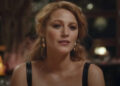 Blake Lively looking forward while wearing a top with black leather straps in It Ends With Us.