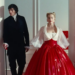 a scene featuring a man and a woman in formal attire standing at doorways